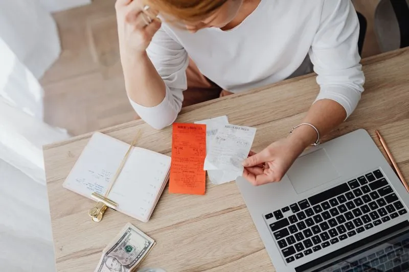 Business owner weighing up a software budget at a desk