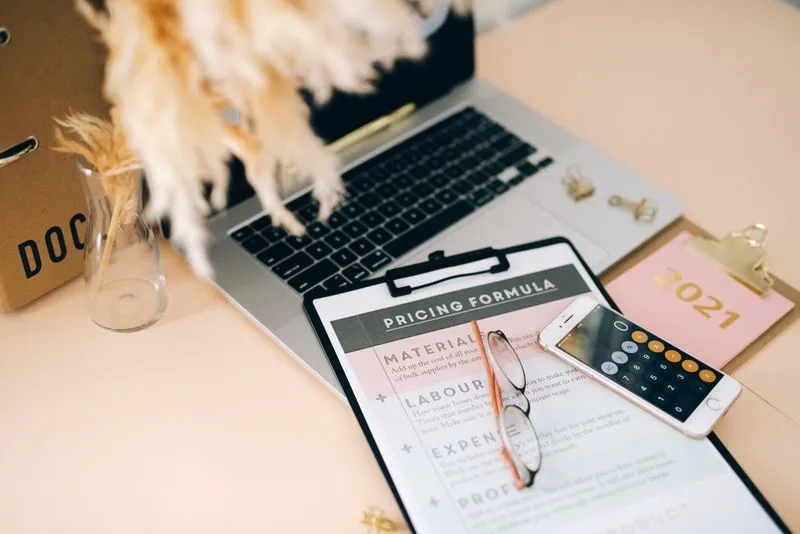 Comparing software subscription costs on a laptop and calculator