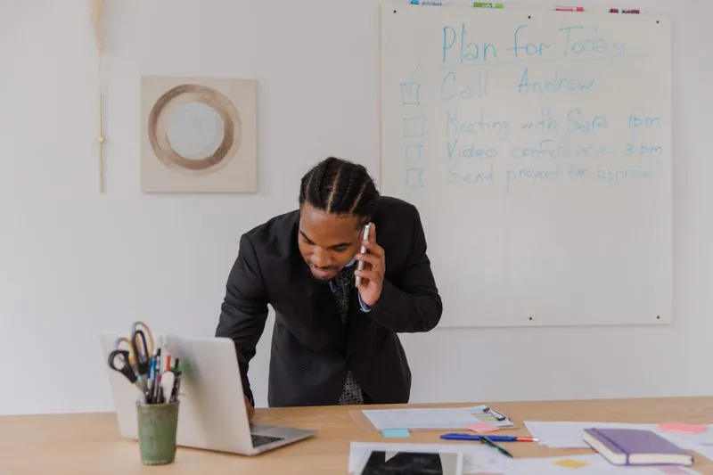 Busy business owner managing multiple tasks at a desk
