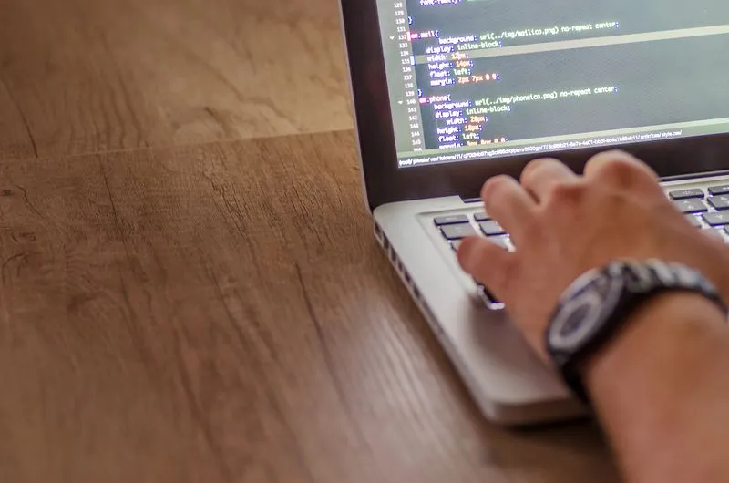Web developer building a custom website on a laptop