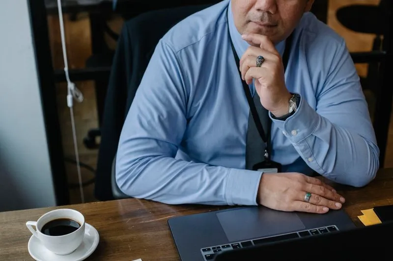 Business owner comparing website platform options on a laptop