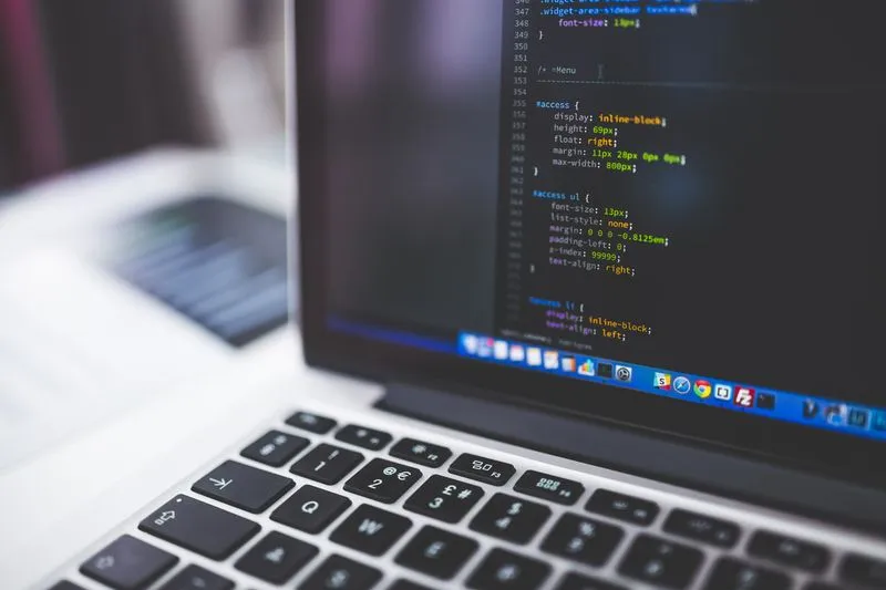Comparing a DIY website builder and custom development on a laptop