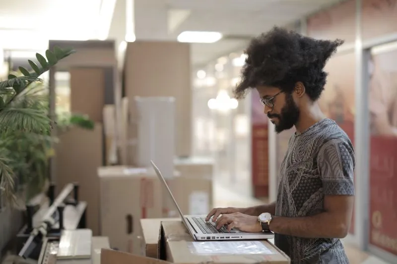 Marketer setting up a social media ad campaign on a laptop