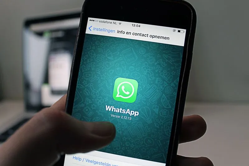 Person sending a WhatsApp message on a smartphone