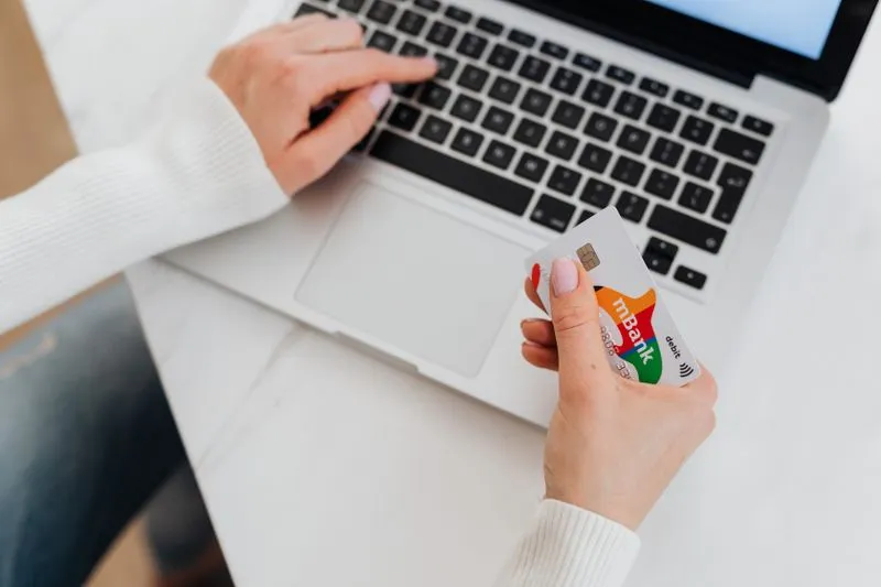 Paying online with a card on a laptop