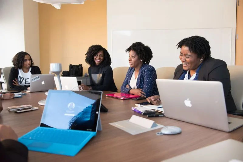 Group of tech community members working on laptops together