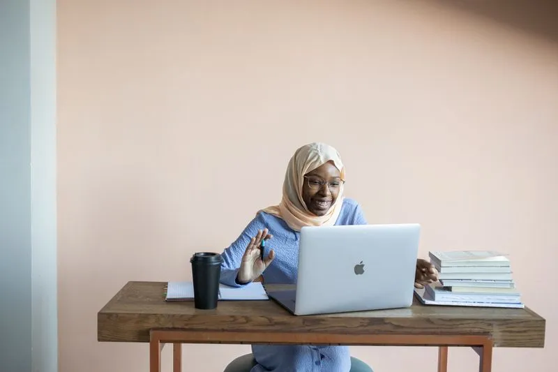 Student taking an online web design course on a laptop