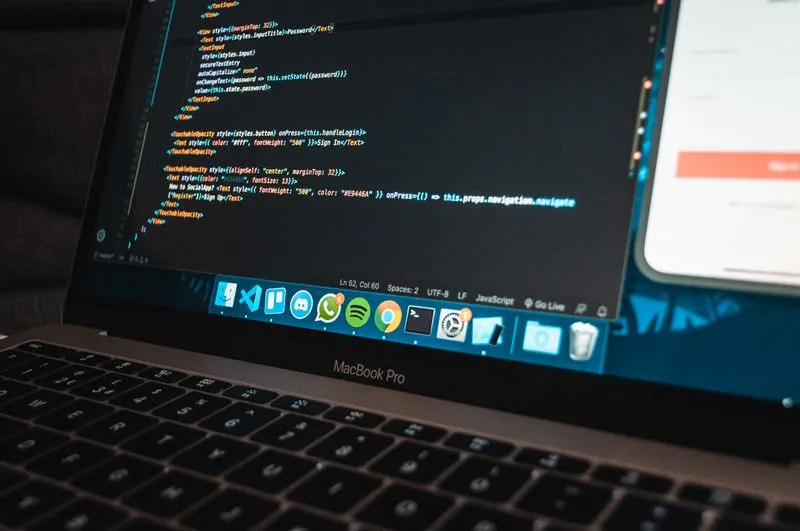 Website code open in an editor on a laptop screen