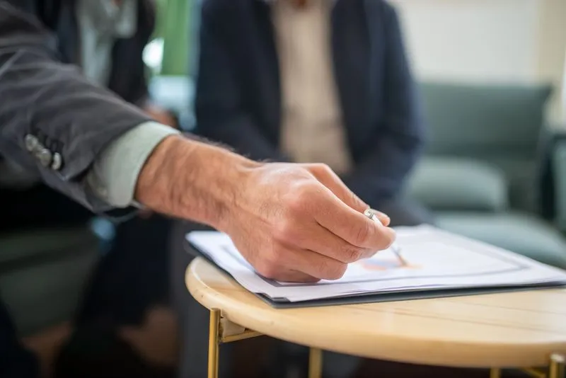Business professionals reviewing a proposal in a meeting