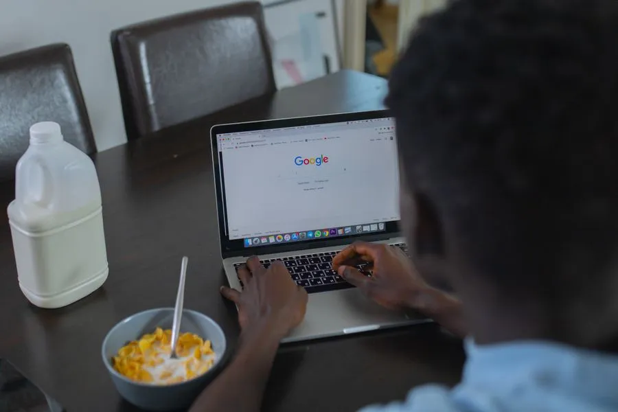 Nigerian small business owner reviewing SEO results on a laptop