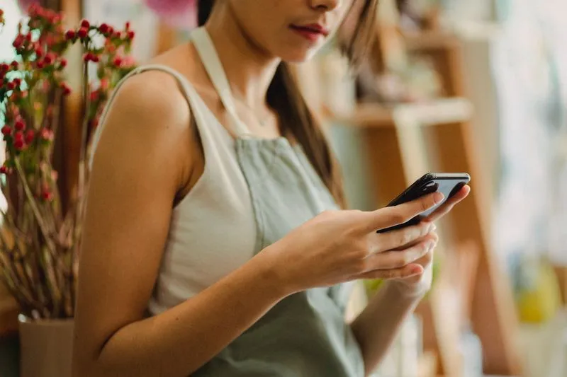 Small business owner using social media on a phone