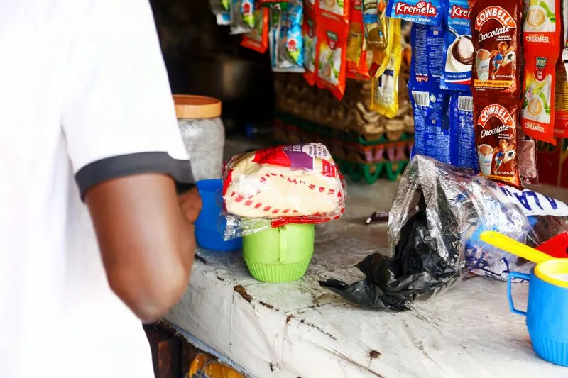Small business owner at a shop counter with a phone