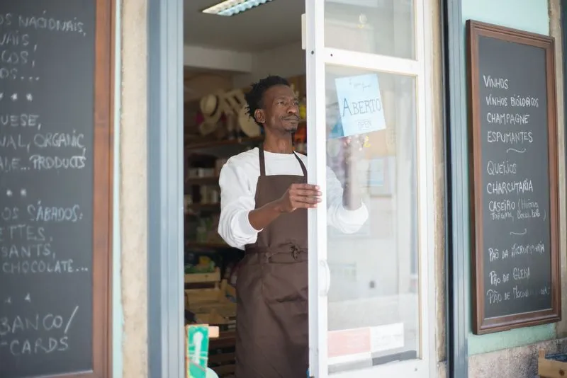 Business owner messaging a customer on a phone