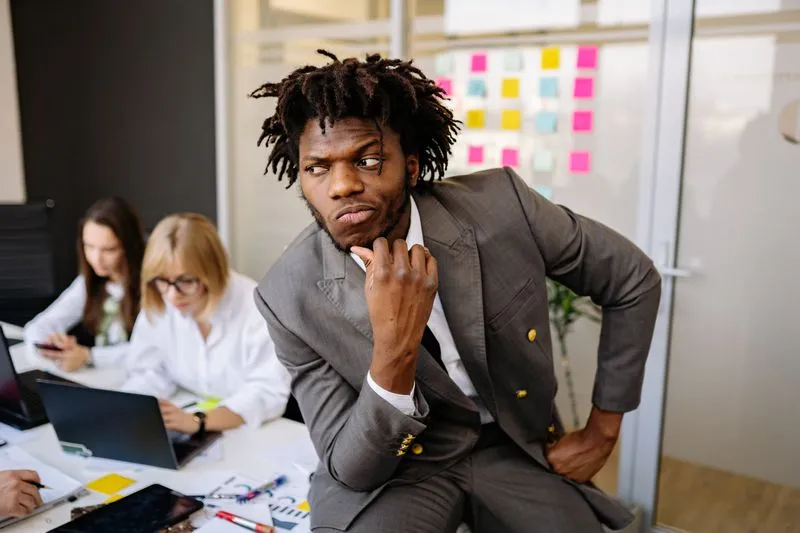 Business owner weighing a decision at a laptop